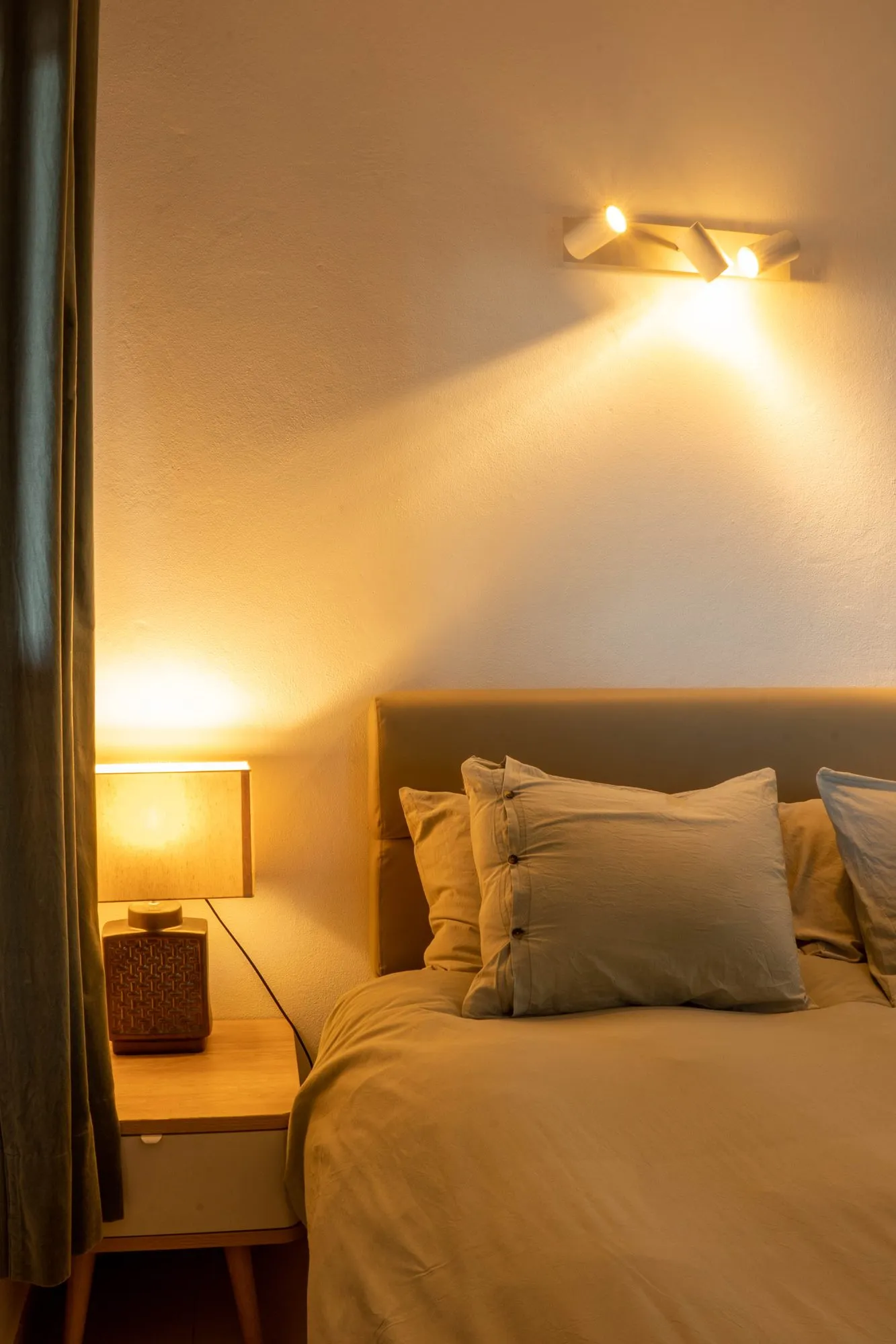 A bedroom by lamplight