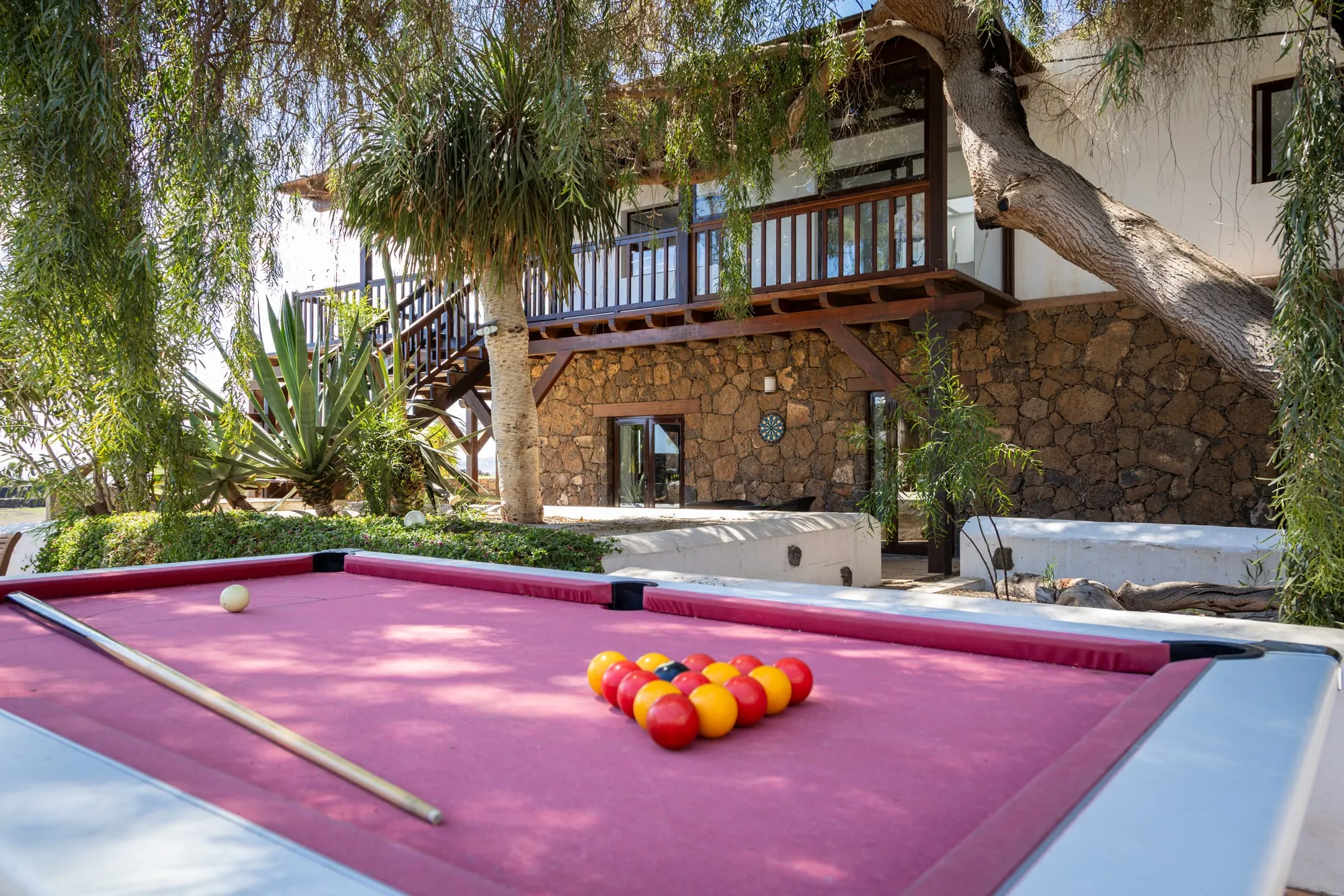 The outdoor pool table, under the trees