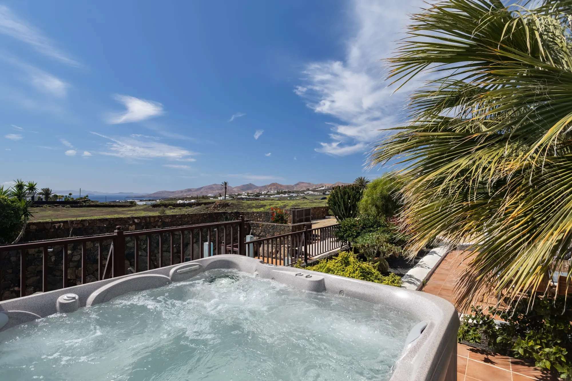 The hot tub on the upper deck, with the hills beyond the garden